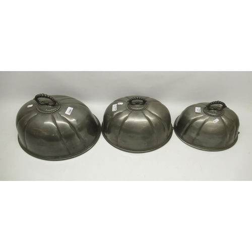 1209 - Three pewter graduated meat covers W41cm