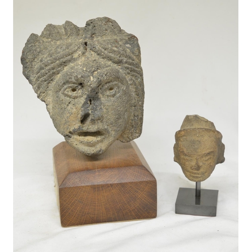 37 - Two carved stone heads on wood and stone plinths, origins unknown, larger carving with plinth 23cm. ... 