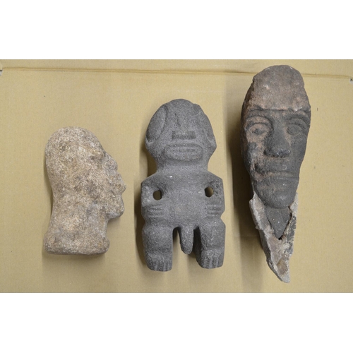 49 - Three carved stone heads depicting an African man, an Aztec fertility symbol, other unknown with att... 