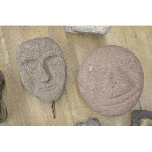 50 - Collection of carved stoneware to include faces, a wolf head, one composite head on plinth, etc. (13... 