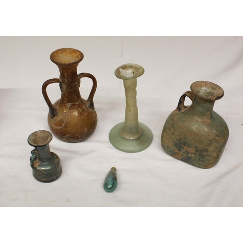 69 - Collection of five glassware antiquities of various styles and periods, to include a candlestick, ju... 