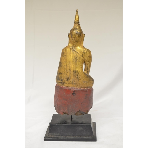 62 - 18/19th century wood carved Buddha on plinth with gilded finish with red seat, overall height 34cm (... 