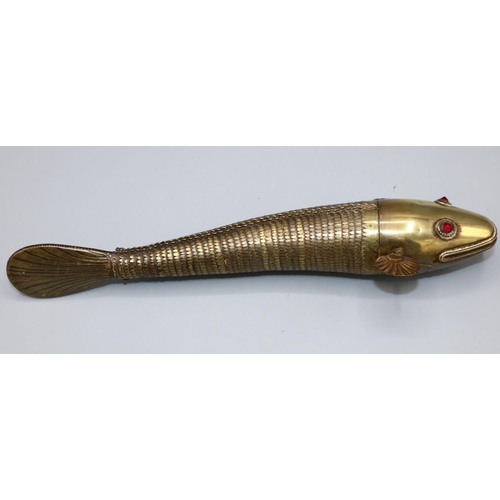 1634 - Early 20th century articulated brass Indian Medina style fish, red paste eyes, L23.5cm