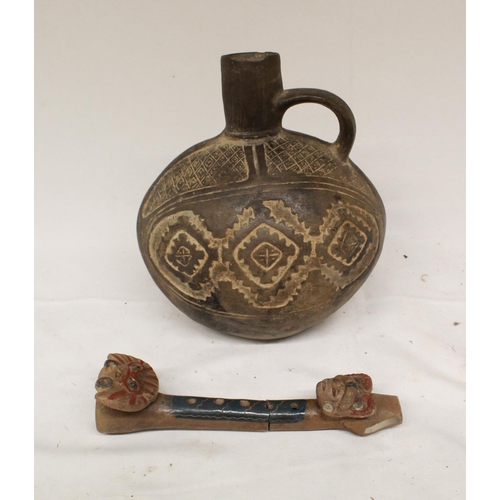 99 - A small embossed ceramic jug in the Indo-Peruvian style. Accompanied by a ceramic flute in the same ... 