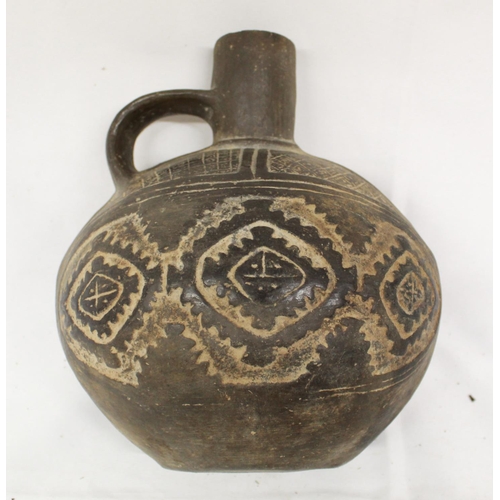 99 - A small embossed ceramic jug in the Indo-Peruvian style. Accompanied by a ceramic flute in the same ... 