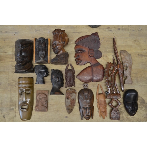 91 - A large collection of wooden masks and carvings of various ages and styles, originating from across ... 