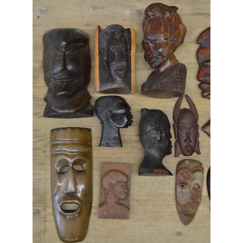 91 - A large collection of wooden masks and carvings of various ages and styles, originating from across ... 