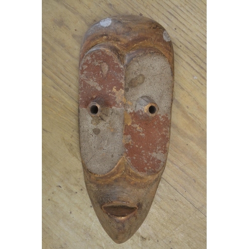 91 - A large collection of wooden masks and carvings of various ages and styles, originating from across ... 