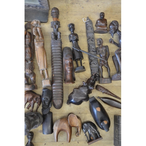 94 - A large collection tourist souvenirs, originating from across Africa. To include wooden elephants, c... 