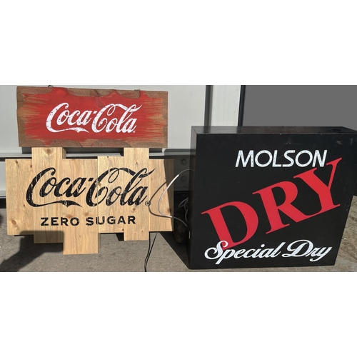 1833 - Three contemporary bar signs, comprising two wooden Coca-Cola signs, and an illuminated Molson Dry S... 