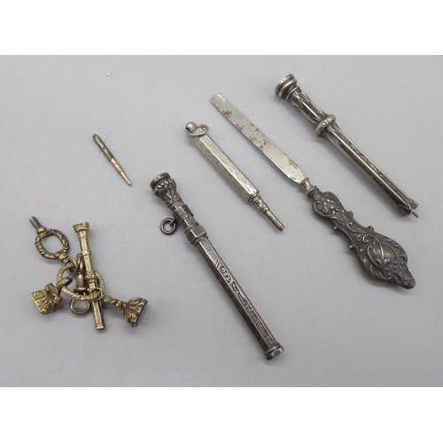 1028 - Yellow metal fob charms and key, two Victorian white metal propelling pencils and other white metal ... 