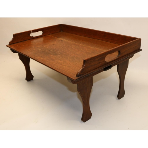 1319 - Oak lap tray with folding legs, stamped  'FAULKNERS PATENT', 55 x 28 x 38cm