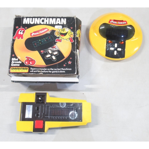 1653 - Two vintage hand held computer games, comprising Grandstand Munchman with box, and a CGL Galaxy Inva... 