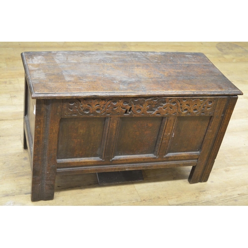 978 - 18th century oak coffer with spilt pin hinged top, three panel front with strapwork carved frieze an... 