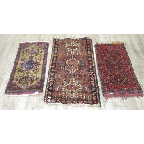 938 - Persian red ground saddle bag and two small Caucasian rugs, 120cm x 70cm max (3) (Victor Brox collec... 