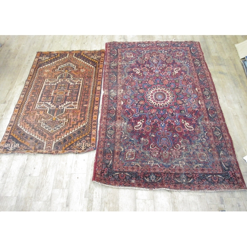 939 - Persian red ground floral pattern rug, 212cm x 137cm and a small Caucasian rug with stepped medallio... 