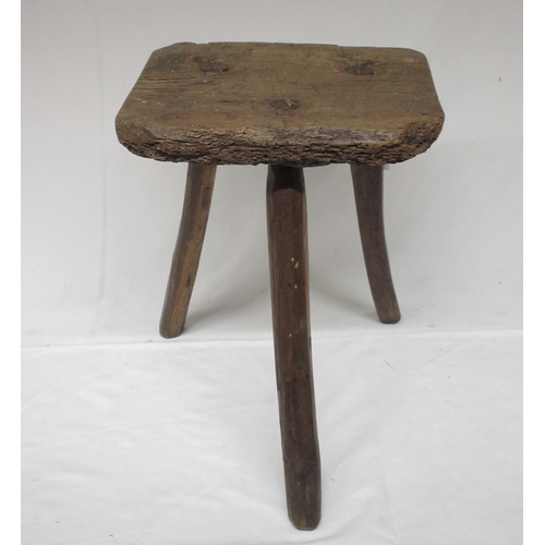 956 - 19th century Country made elm three leg low stool, shaped rectangular seat on three naturalistic sup... 