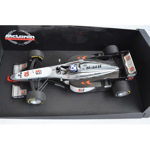 54 - Four boxed 1/18 scale Formula 1 racing car models from Paul's Model Art/Minichamps, all McLaren Merc... 