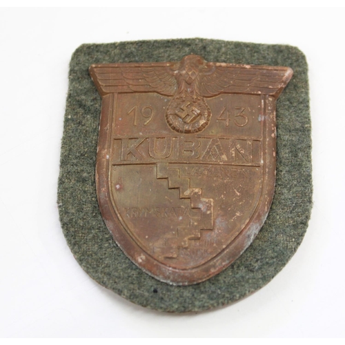 244 - Kuban sleeve shield 1943 on Wehrmacht  green backing cloth with backing paper and four prongs intact... 