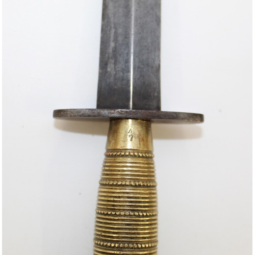 253 - Fairbairn-Sykes commando knife with ribbed and beaded brass grip, complete with sheath, No. 7 and br... 