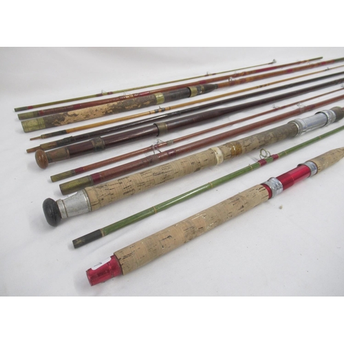 265 - Selection of four vintage fishing rods, all with signs of age-related wear. To include two unmarked ... 