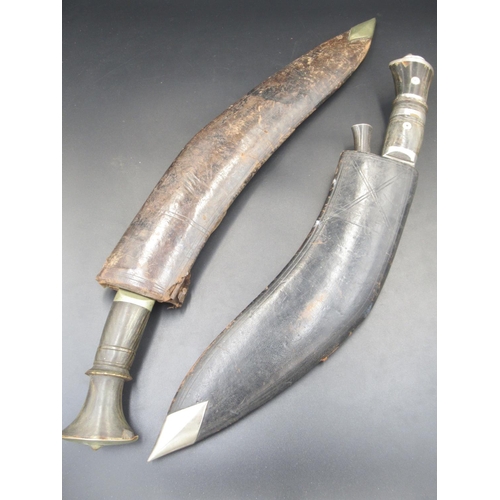 255 - A Buffalo-horn-handled Kukri with decorative lion's head, complete with original sheath. Missing one... 