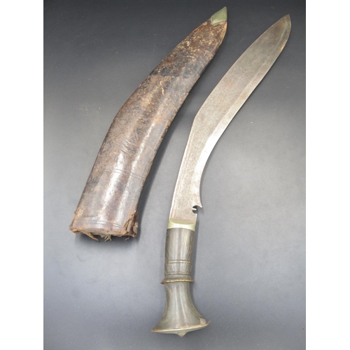 255 - A Buffalo-horn-handled Kukri with decorative lion's head, complete with original sheath. Missing one... 