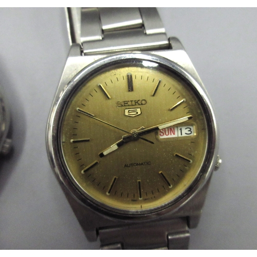 502 - Two Seiko 5 7S26 Middle Eastern and European market stainless steel automatic wristwatches with day ... 