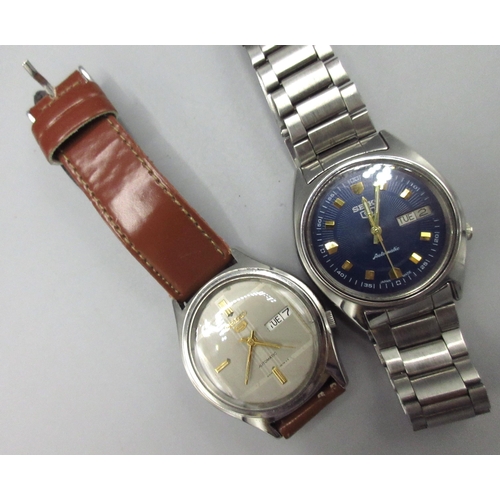 506 - Two Seiko 5 7009 Middle Eastern and European market stainless steel automatic wristwatches with day ... 