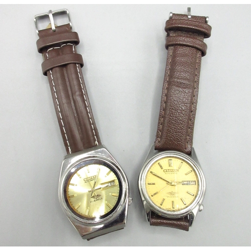 515 - Two Citizen Middle Eastern market stainless steel automatic wristwatches with day date, nos. 2120021... 