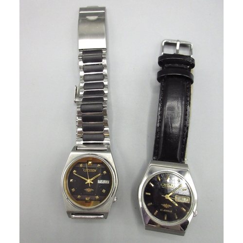 516 - Two Citizen Middle Eastern market stainless steel automatic wristwatches with day date, nos. 9040204... 