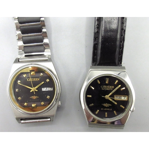 516 - Two Citizen Middle Eastern market stainless steel automatic wristwatches with day date, nos. 9040204... 