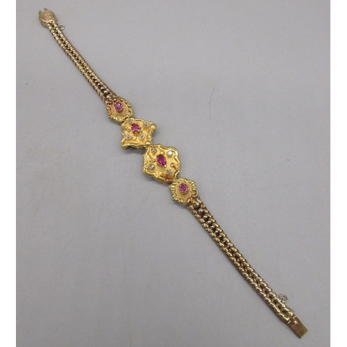 1 - Unmarked yellow gold bracelet with ruby and diamond set panels on articulated chain, tested to 22ct ... 