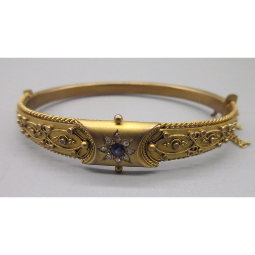 11 - 9ct yellow gold hinged bangle, with central floral sapphire and diamond cluster, half of the bangle ... 