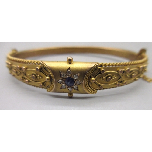 11 - 9ct yellow gold hinged bangle, with central floral sapphire and diamond cluster, half of the bangle ... 