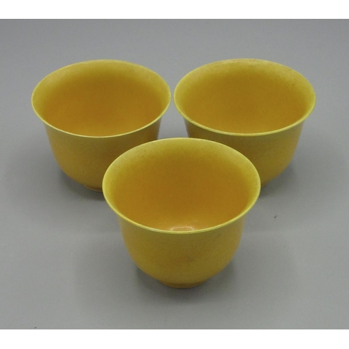 1005 - Three yellow glazed Chinese tea cups with Guangxu mark, the outside decorated with five claw dragon,... 