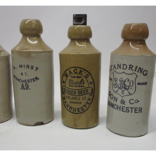 205 - A collection of fifteen stoneware ginger beer and stout bottles from the Manchester area, including ... 