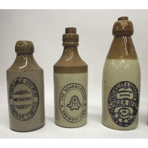 209 - A collection of nine stoneware ginger beer and stout bottles from across Yorkshire, including Leeds,... 