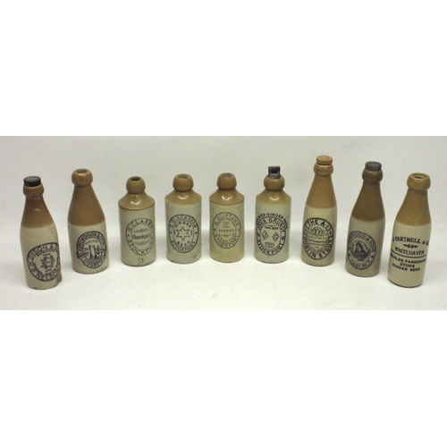 213 - A collection of nine stoneware ginger beer and stout bottles from across northern England, including... 