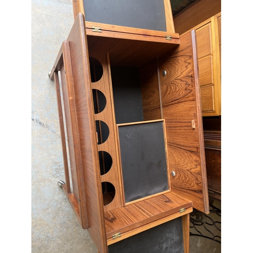 603 - Mid 20th century teak drinks trolley, hinged top revealing internal shelf and five bottle compartmen... 