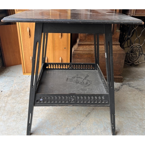 606 - JAS Schoolbred, Aesthetic movement black painted two tier occasional table, the undertier with pierc... 