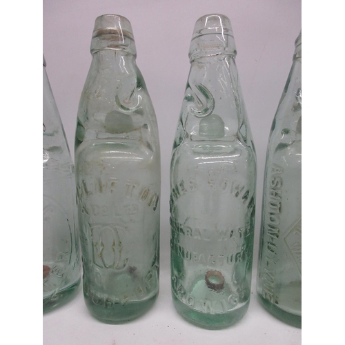 215 - Collection of seventeen Codd-neck glass bottles from across the Greater Manchester area, including M... 