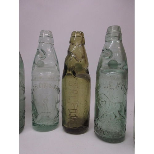 215 - Collection of seventeen Codd-neck glass bottles from across the Greater Manchester area, including M... 