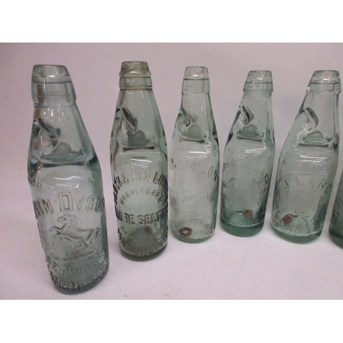 215 - Collection of seventeen Codd-neck glass bottles from across the Greater Manchester area, including M... 