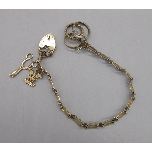 33 - 9ct yellow gold charm bracelet with padlock closure, set with three 9ct yellow gold charms, stamped ... 