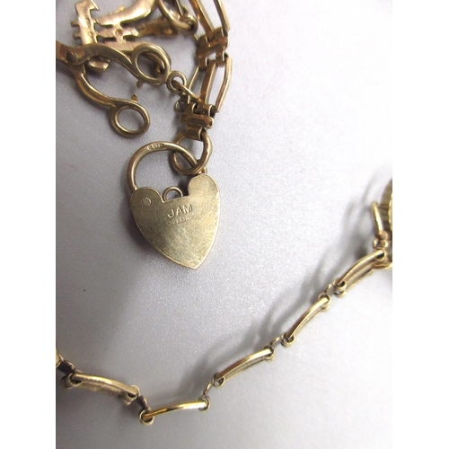 33 - 9ct yellow gold charm bracelet with padlock closure, set with three 9ct yellow gold charms, stamped ... 