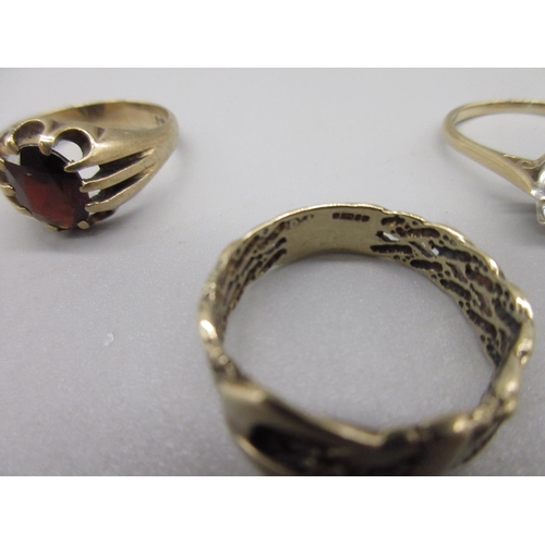 34 - 9ct yellow gold belt buckle ring, size T, a 9ct gents ring set with red stone, size S1/2, and a 9ct ... 