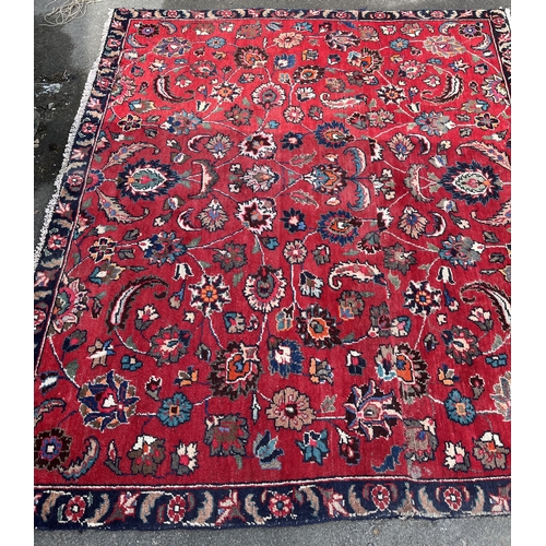 1294 - Persian red ground floral pattern rug, 180cm x 160cm