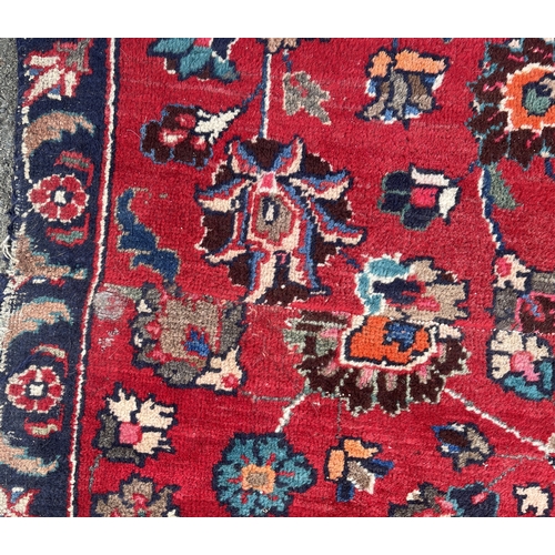 1294 - Persian red ground floral pattern rug, 180cm x 160cm