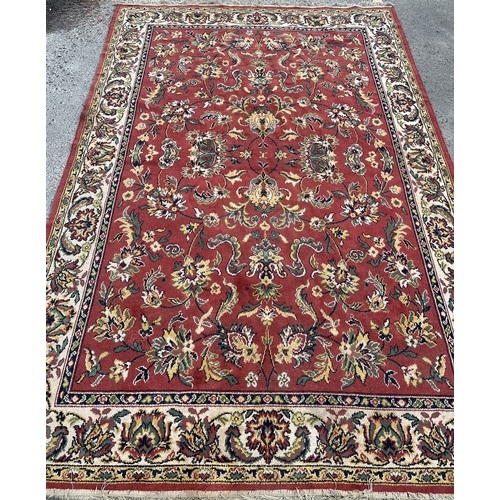 1295 - Belgian Persian pattern red ground rug, 265cm x 175cm